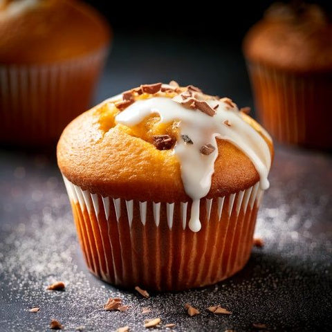 Muffin topped with icing and chocolate shavings made with Sweet Like Sugar.