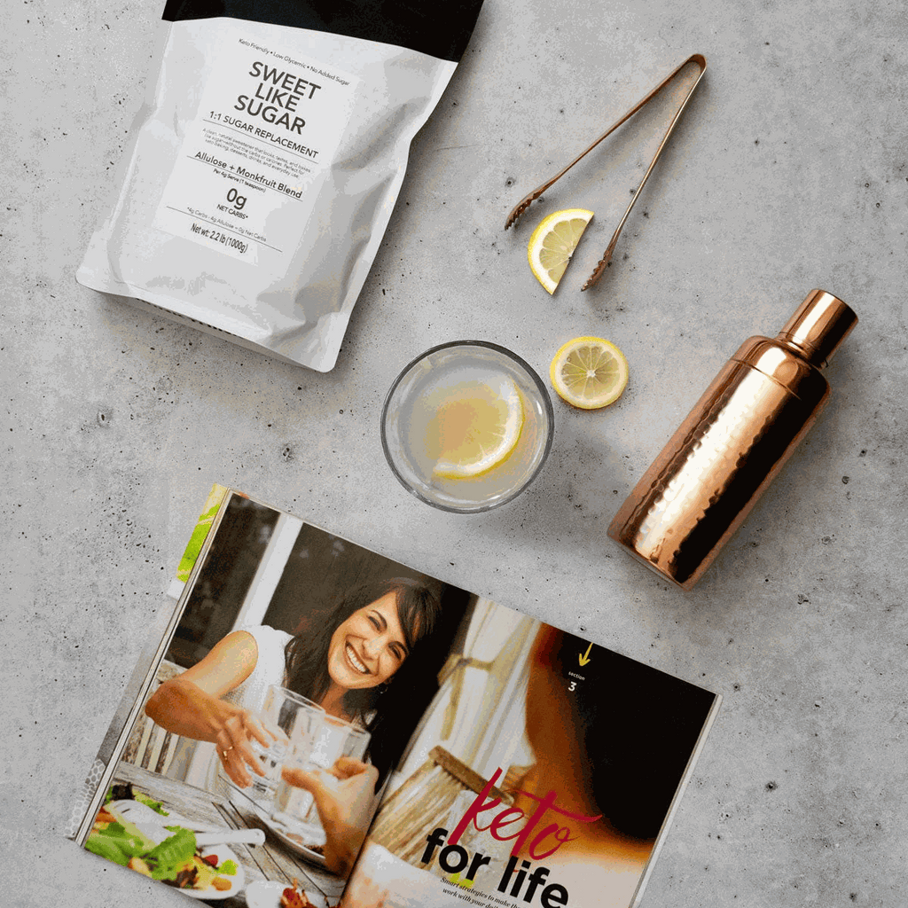 Sweet Like Sugar product with measuring cup, shaker, lemon slices, and magazine.