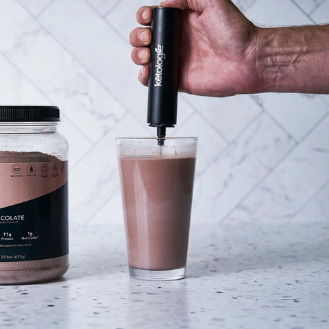 Rechargeable Ketologie frother/mixer making chocolate drink with USB charging feature.